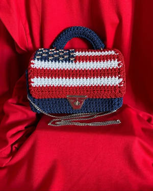 Handmade crochet top-handle bag with a stars-and-stripes American flag design and gold clasp